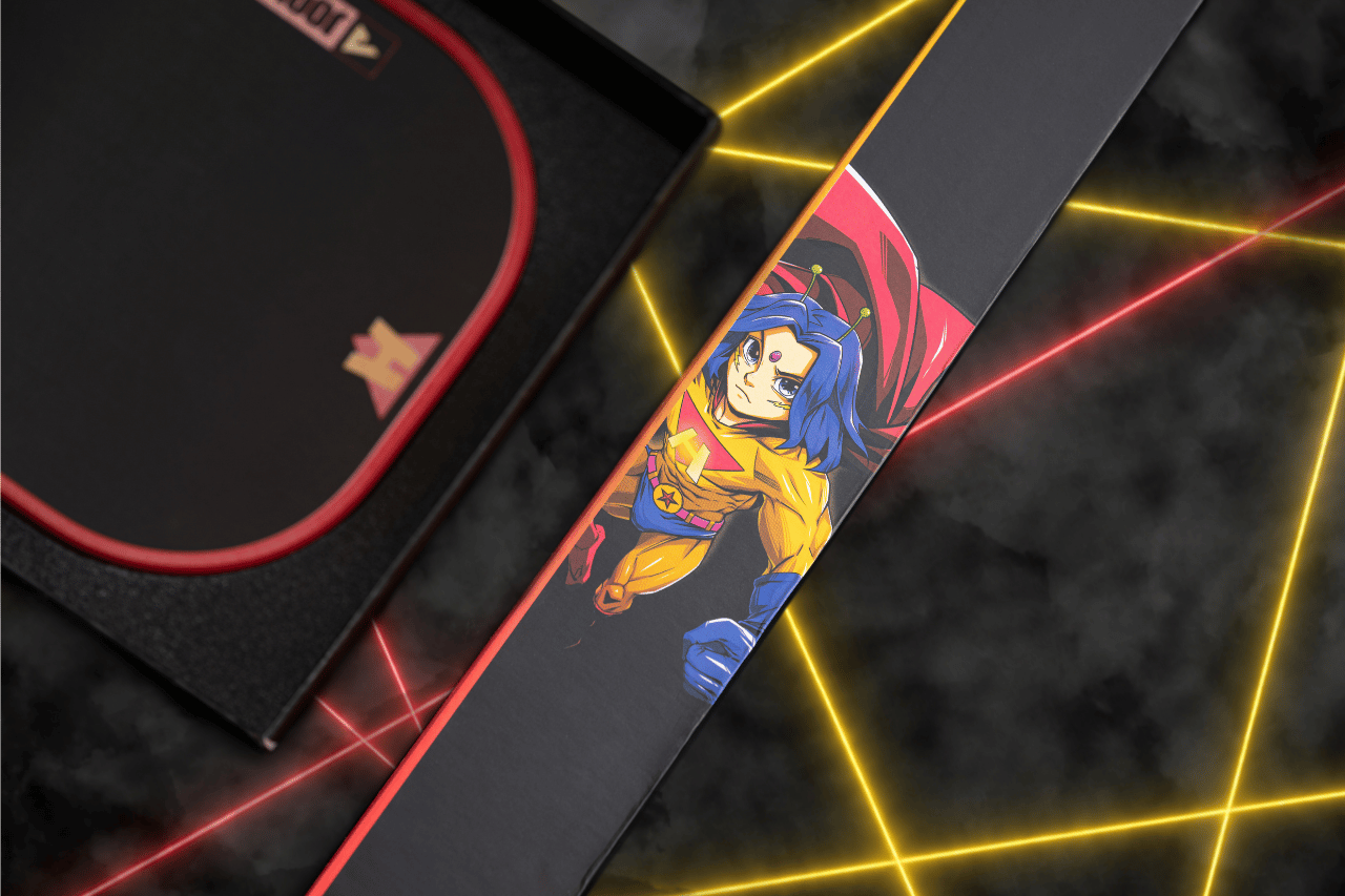 Close up of the HiroQuest character on the side of a JOOLA x Steve Aoki table tennis colloboration packaging.
