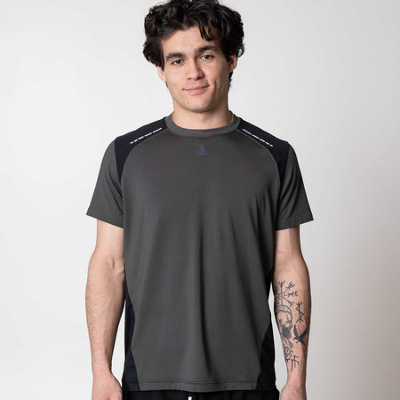 Gray background, man wearing a Hybrid Short Sleeve shirt.