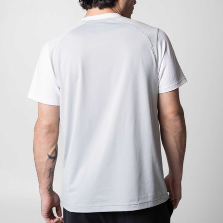 Gray background, image of the back of a JOOLA Hybrid Short Sleeve white shirt.