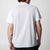 Gray background, image of the back of a JOOLA Hybrid Short Sleeve white shirt.