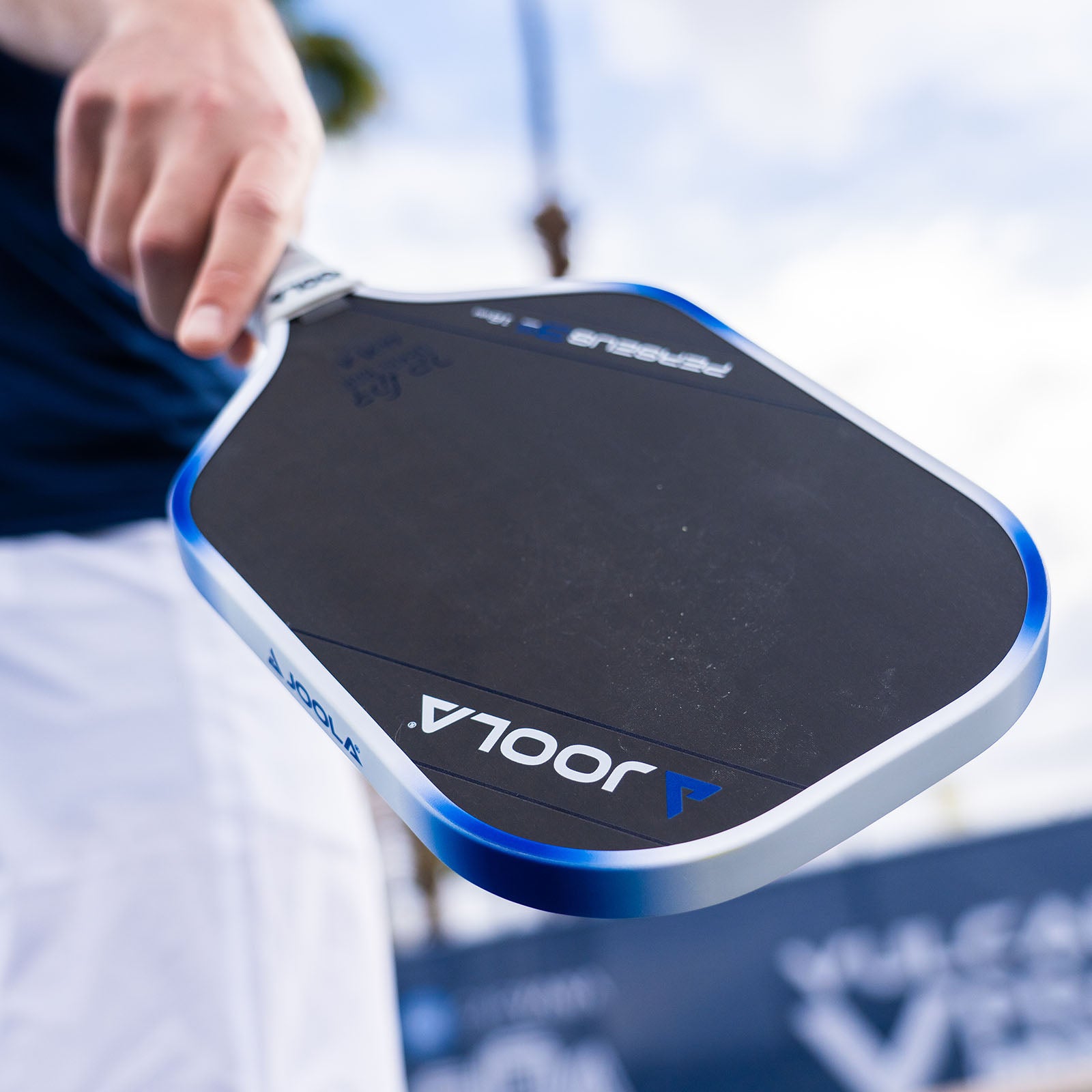 Close up image of the paddle face of the JOOLA Dekel Bar Perseus Pickleball Paddle, Blue and White color way.