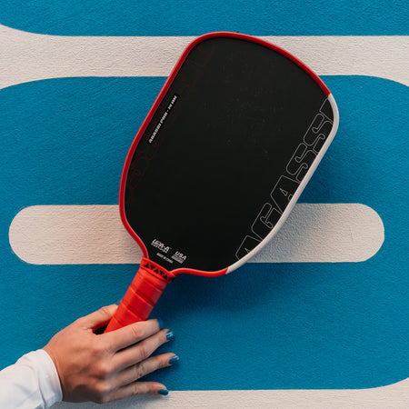 Close up image of the Agassi x JOOLA Agassi 14mm Pro Pickleball Paddle in the hand of a JOOLA Pro Pickleball Player.