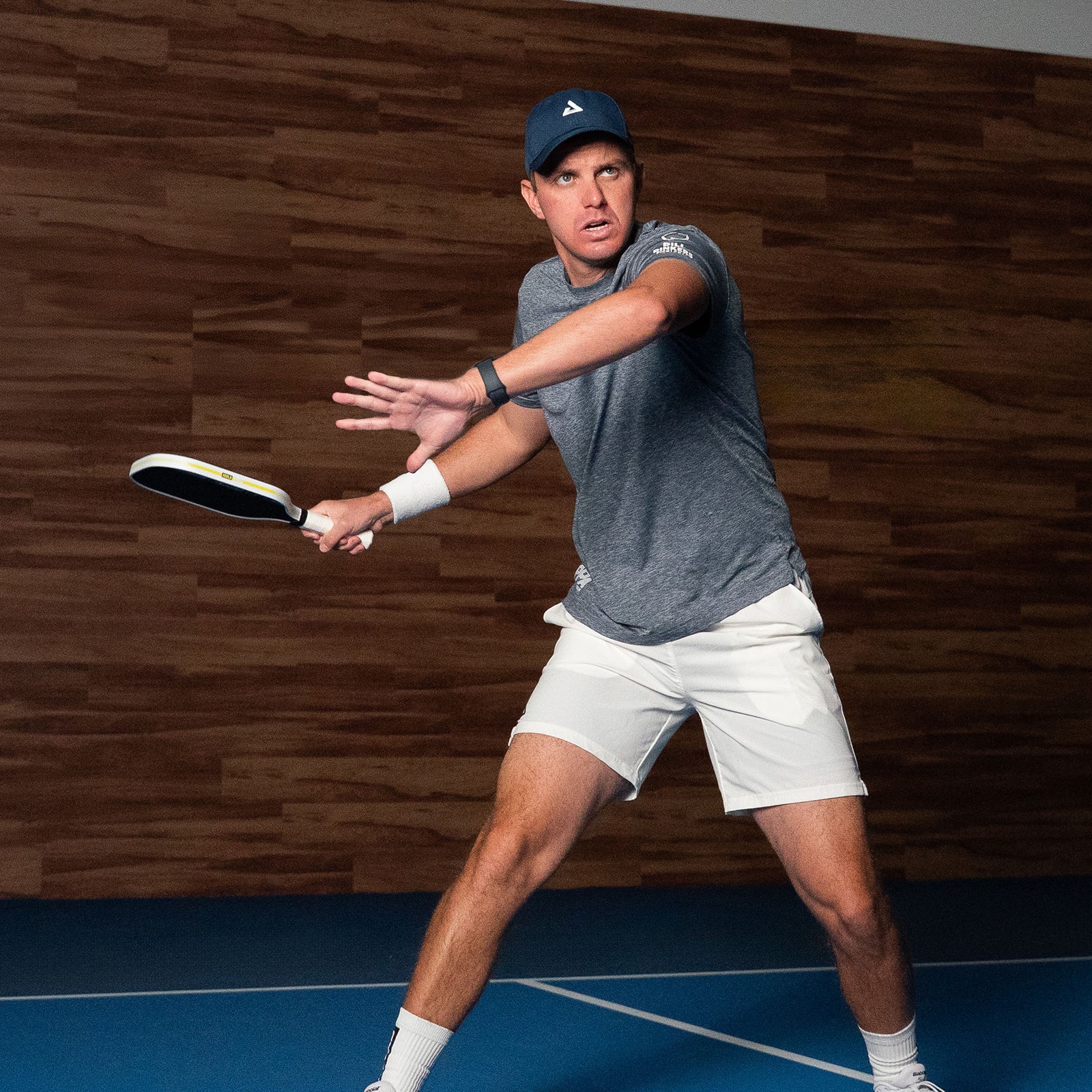 Image of JOOLA Pro Collin Johns holding the JOOLA Collin Johns Scorpeus Pro IV Pickleball Paddle at an indoor facility. 16mm.