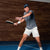 Image of JOOLA Pro Collin Johns holding the JOOLA Collin Johns Scorpeus Pro IV Pickleball Paddle at an indoor facility. 16mm.