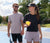 Image of two models, one male and one female on the pickleball court. The female model is holding a paddle and a ball and the male model is holding a paddle. Both are wearing JOOLA apparel.