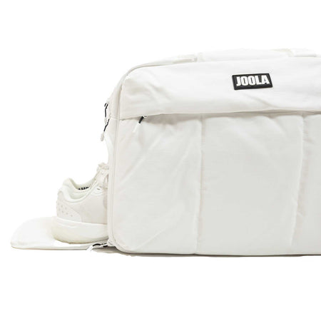 White background, white JOOLA branded bag with hidden shoe compartment pictured.