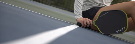 Banner image showing an angled court and a person holding a JOOLA Scorpeus 3S pickleball paddle.
