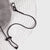 Close-up of a white brim with a black lanyard and 'JOOLA' branding on a light gray background.