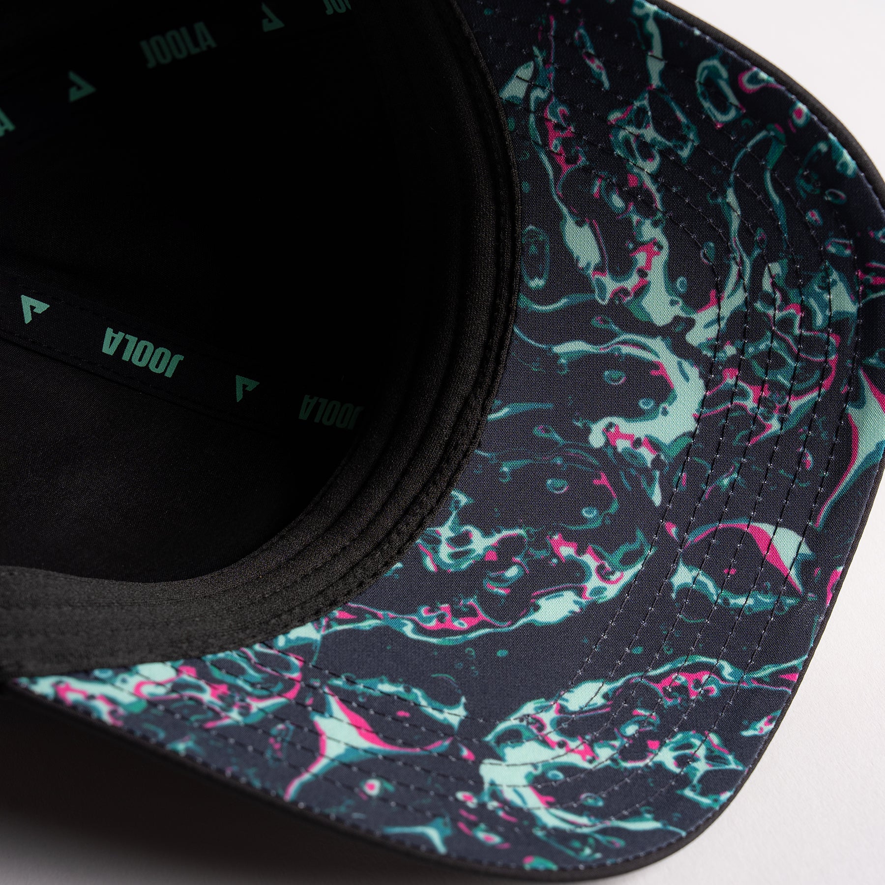 JOOLA Essential hat with a coloful aquatic pattern on the underside of the hats brim.
