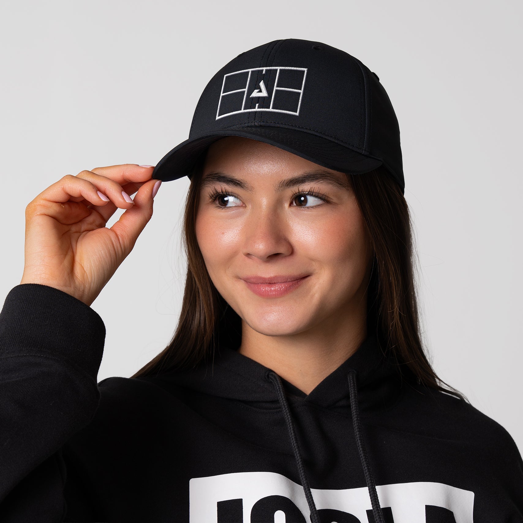 Image of a female model wearing a JOOLA Court Hat, black and white.
