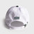 White and green JOOLA Collegiate cap with pickleball club logo on a light gray background. Image shows the details on the back of the hat.