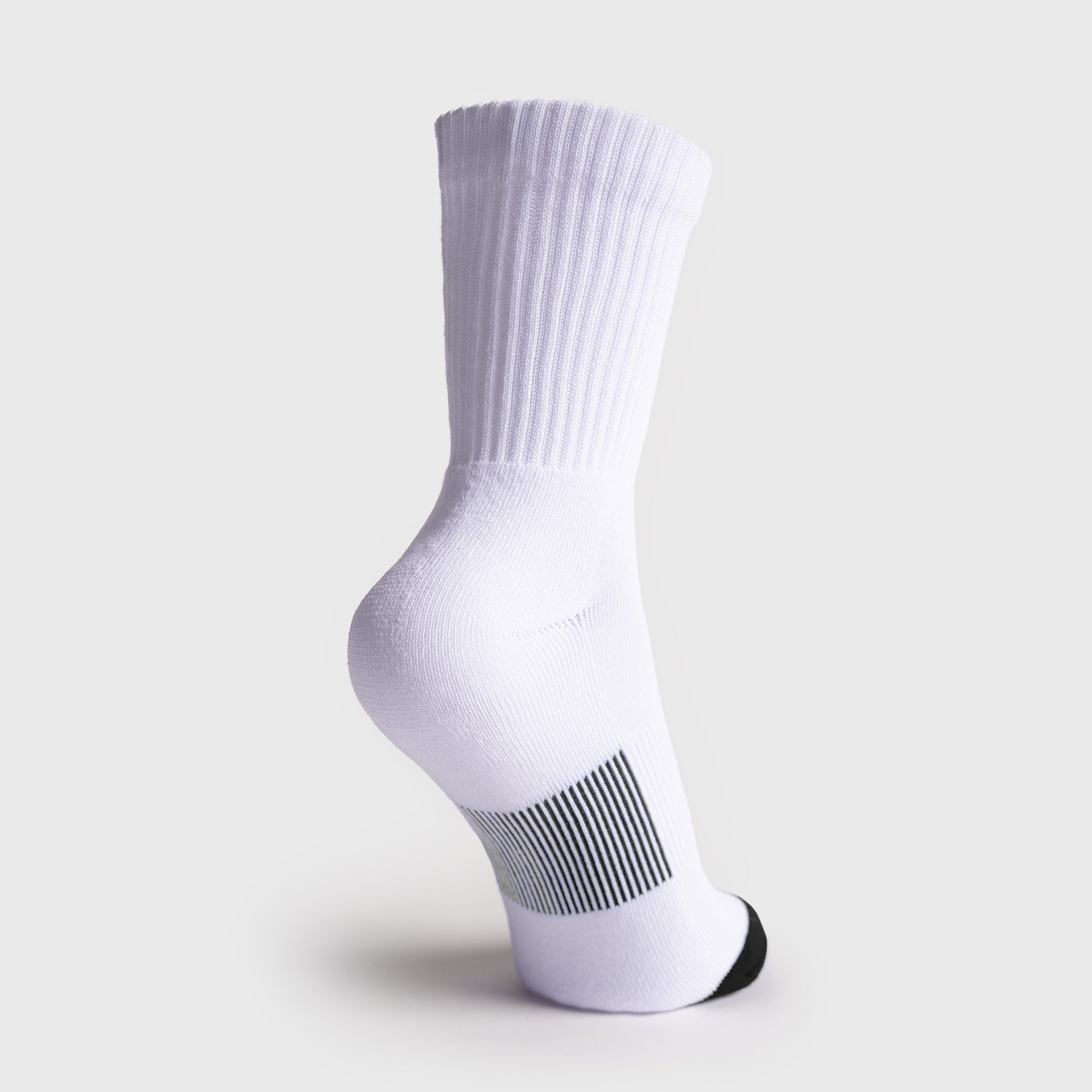A single white JOOLA crew sock shown from the side on a light gray background, featuring a ribbed cuff, a black-and-white striped heel section, and a black toe cap.