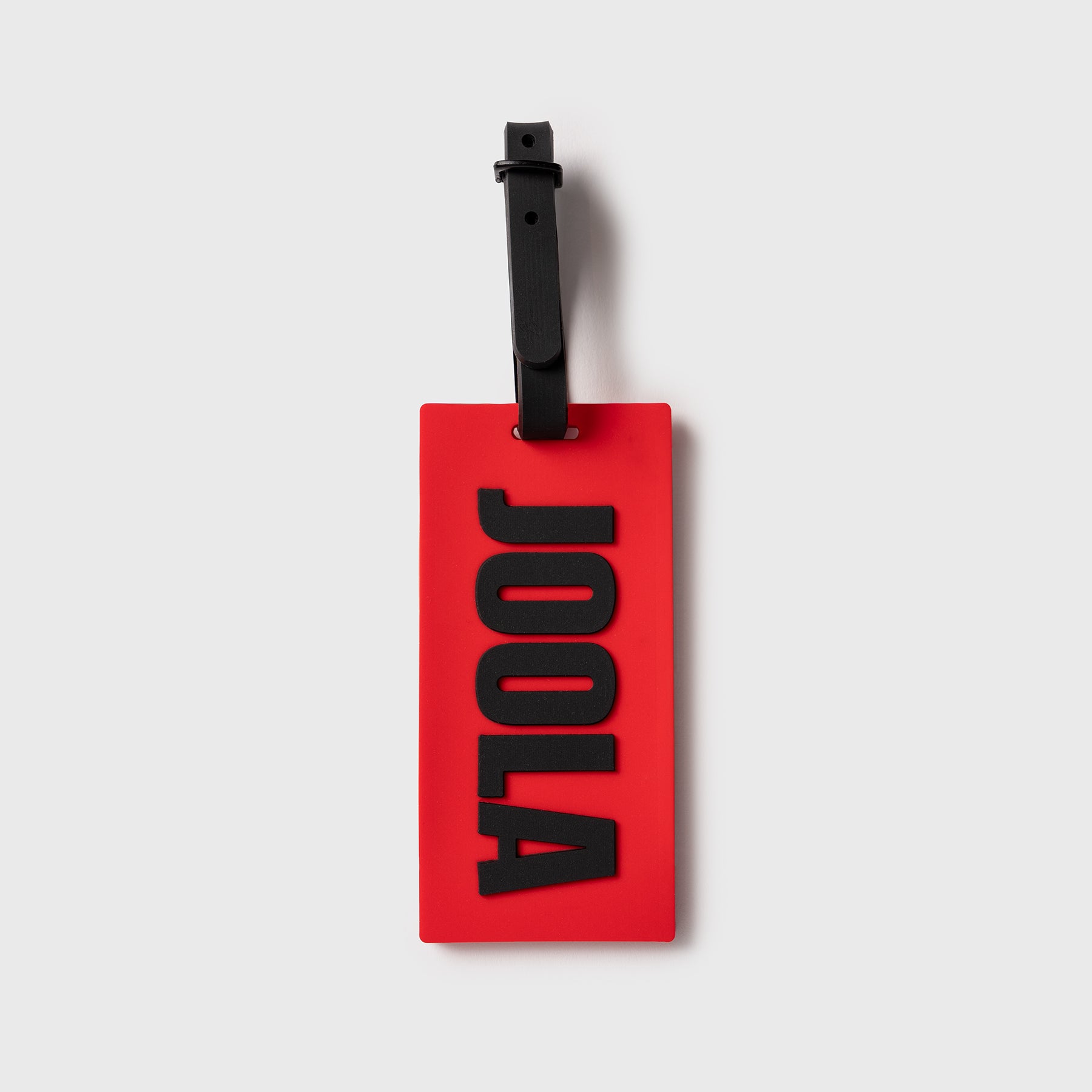 Red JOOLA Luggage tag with 'JOOLA' branding on a white background