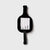 Black paddle-shaped luggage tag with a white label on a light gray background