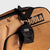 Black JOOLA Micro bag with carabiner attached to a latte and black JOOLA Tour bag.
