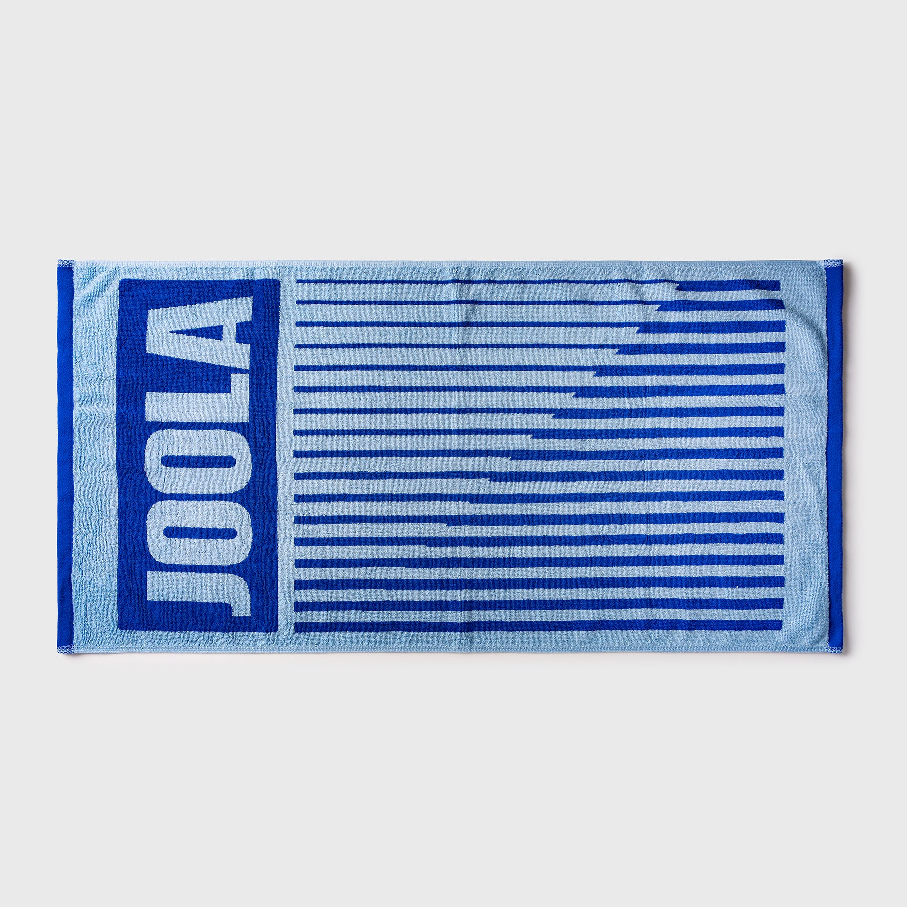 White background, blue and white JOOLA towel.