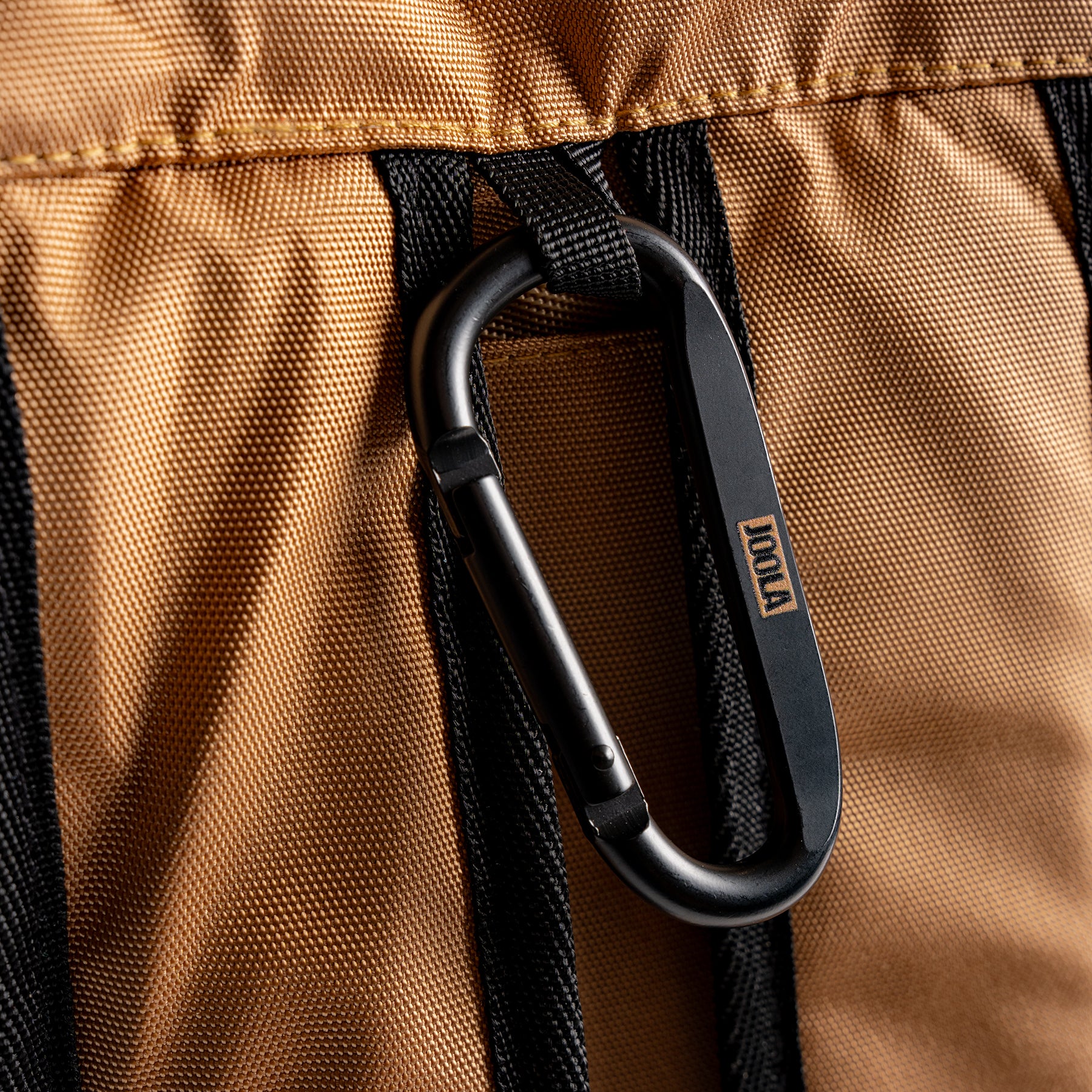 Close up of the JOOLA carabiner hook hanging from a JOOLA Latte colored Pro Pickleball Tour bag.
