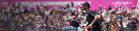 Horizontal header image of Tyson McGuffin playing pickleball with a Magnus Pickleball paddle in front of a large crowd.