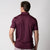 Image showing the back of a male model who is wearing a JOOLA men's club polo, bordeaux.