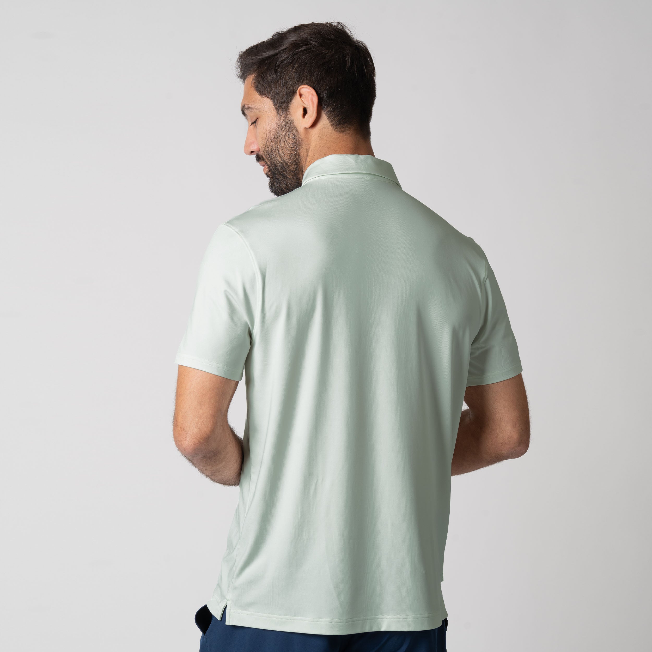 Image showing the back of a male model wearing the JOOLA Men's Club Polo, Hushed Mint.