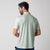 Image showing the back of a male model who is wearing a JOOLA men's club polo, hushed mint.