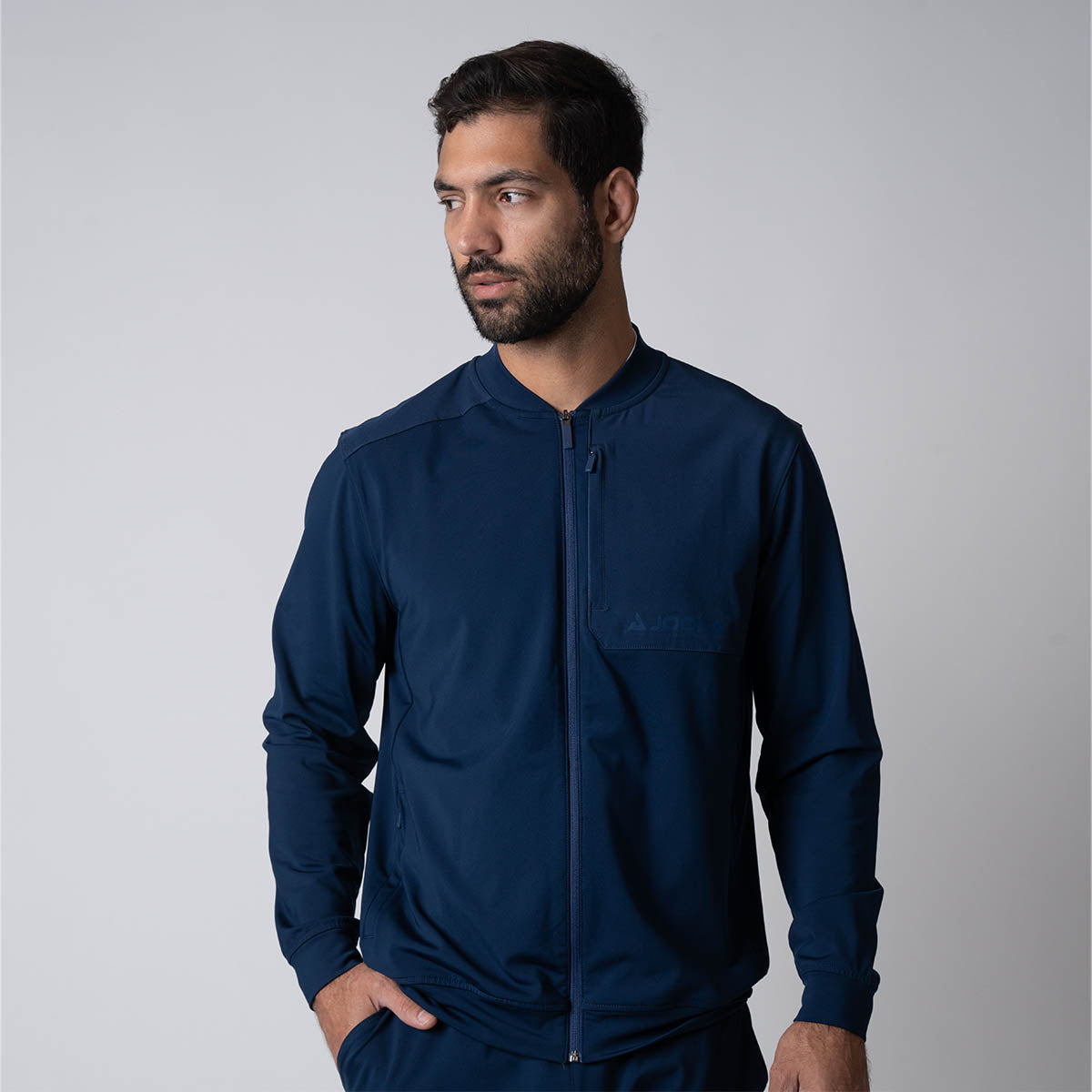 Male model posing in the JOOLA Men's Warm Up Jacket, Navy.