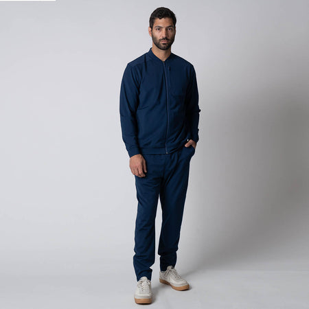 Male model posing in the JOOLA Men's Warm Up Jacket and JOOLA Men's Warm Up Pants, Navy.