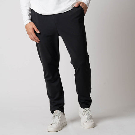 Image of a male model wearing a pair of JOOLA Men's Warm Up pants, black.