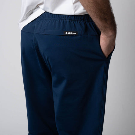 Close up image of the JOOLA logo on the back of the JOOLA Men's Warm Up pants, navy.