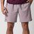 Close up image showing a male model who is wearing a pair of JOOLA Men's Woven Shorts, 7 inch inseam, Dusty Mauve.