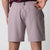 Close up image showing the back zipper pocket and JOOLA logo on the waistband of a pair of JOOLA Men's Woven Shorts, 7 inch inseam, dusty mauve.