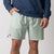 Close up image of a male model who  is wearing a pair of JOOLA Men's Woven Shorts, 7 inch inseam, hushed mint.