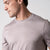 Close up image showing the JOOLA logo over the left chest of a male model who is wearing a JOOLA men's club short sleeve shirt, dusty mauve.