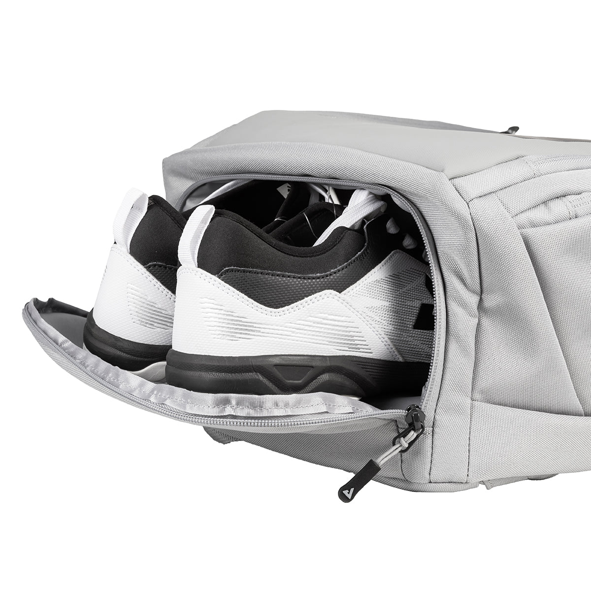 Gray shoe bag with a pair of black and white sneakers inside on a white background.