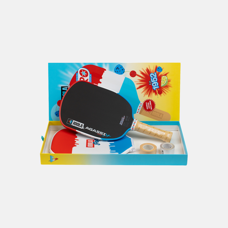 White background, open box of a JOOLA Agassi Pro V Rocket Rally pickleball paddle in an open Rally Rocket package.