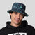 Image of a male model wearing a Aqua Synth pattern JOOLA Bucket hat.