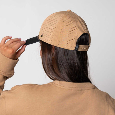 Image showing a femaled model wearing the JOOLA Rope Cap, latte colored with black bill and JOOLA Branding.