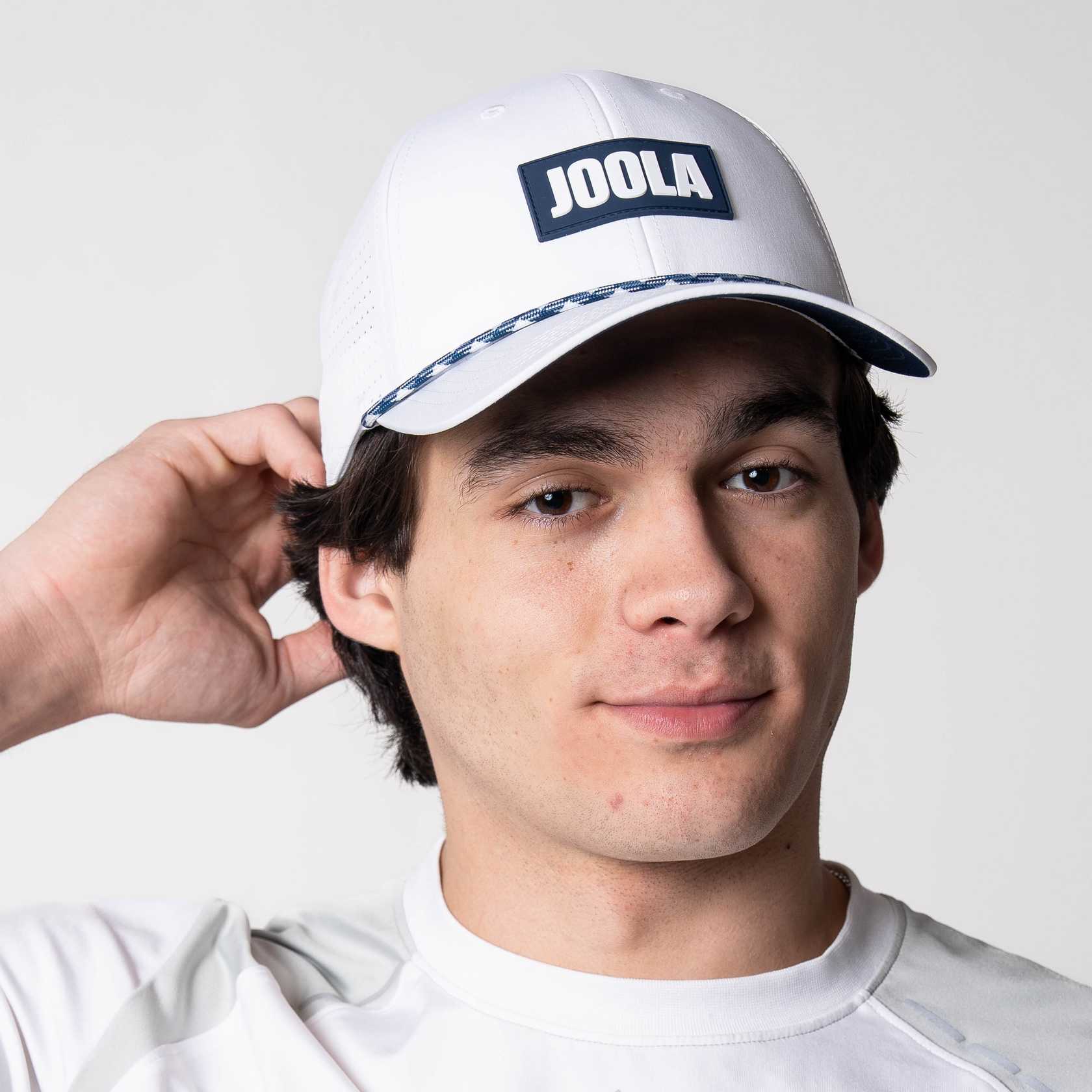 Model showing off the JOOLA Rope Cap, blue and white.