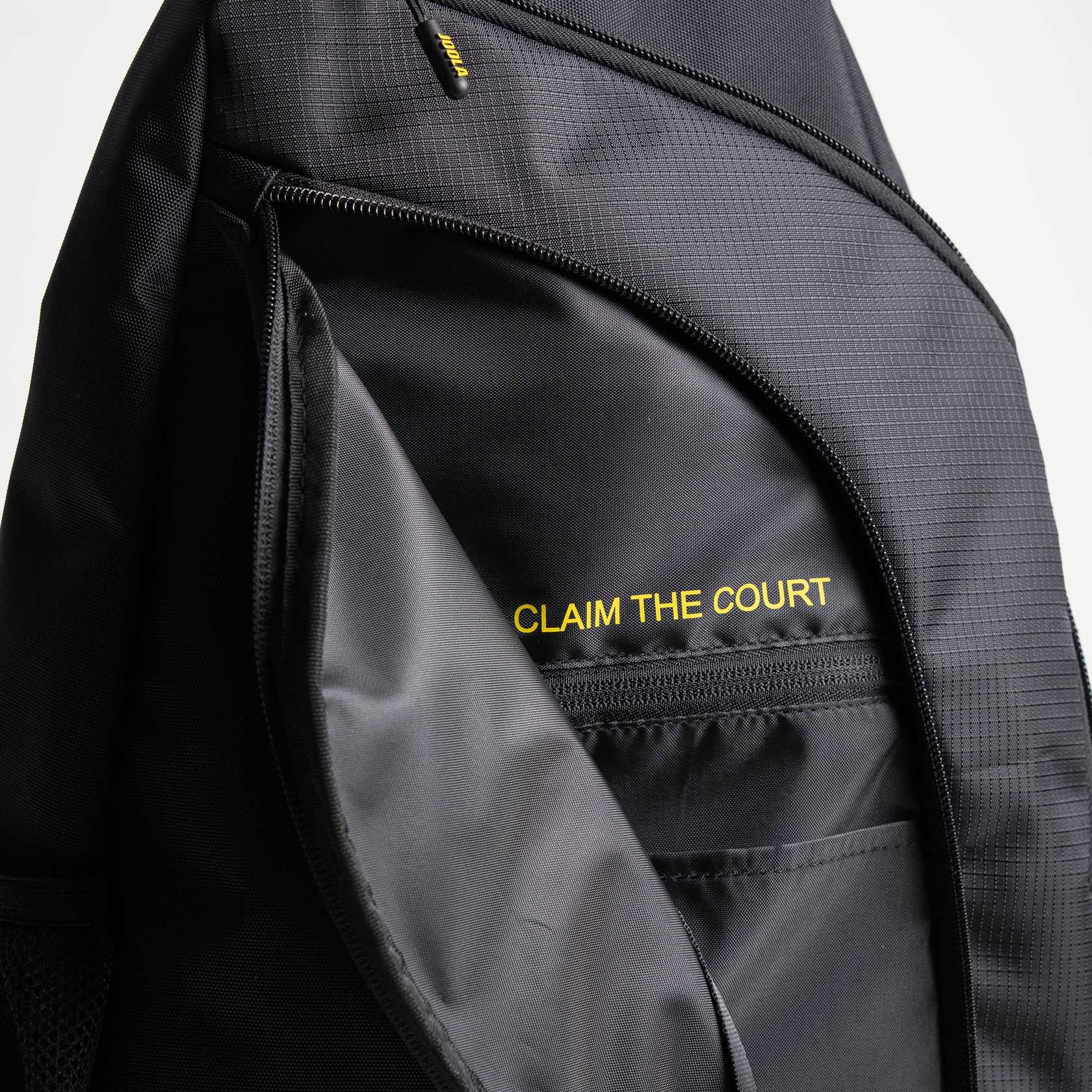 Close up on the inside of the front pocket on the JOOLA Sling bag with the Text 'Claim the Court.'