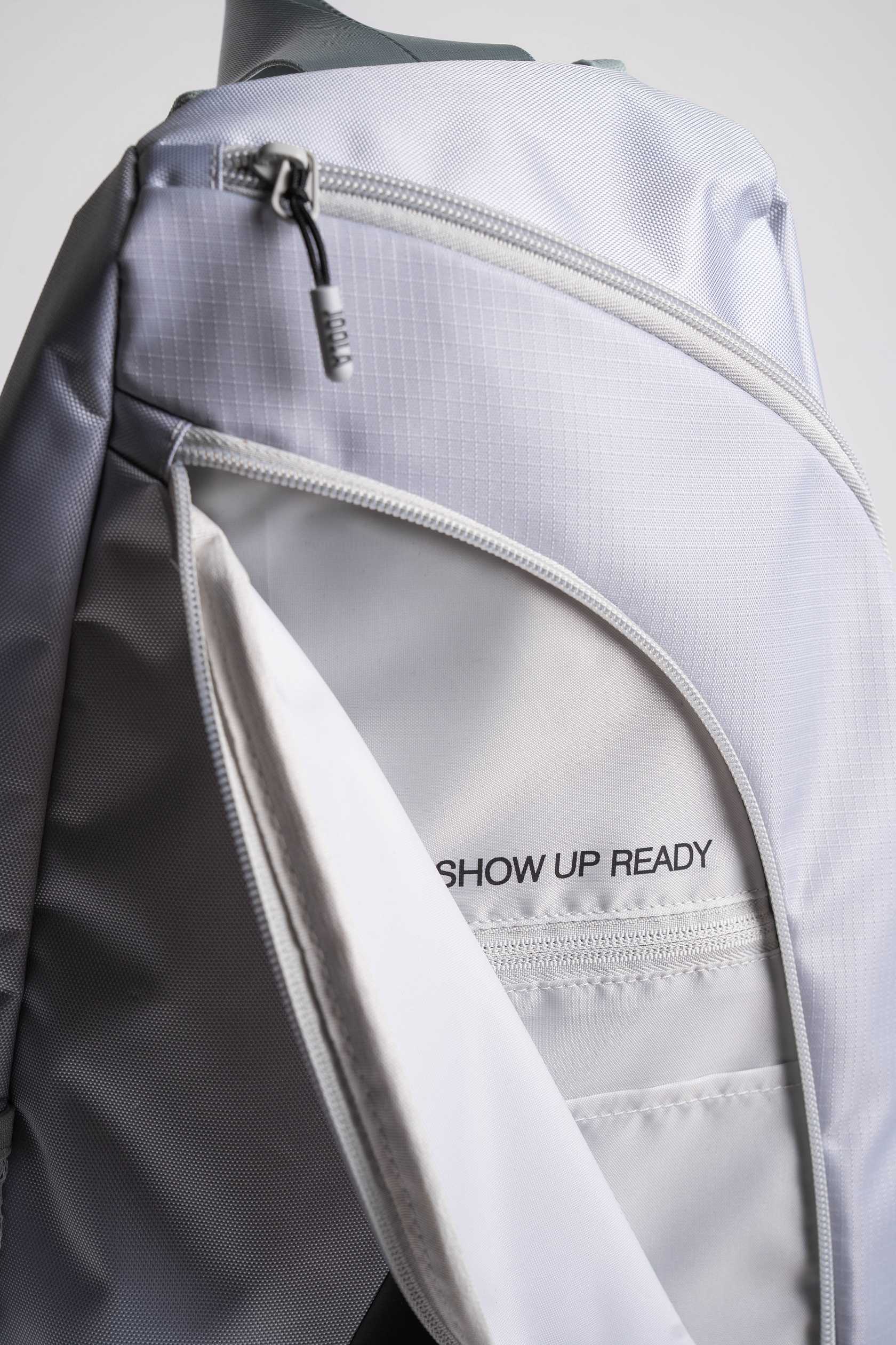 Close up on the text 'Show Up Ready' on the inside of the JOOLA Sling Bag.