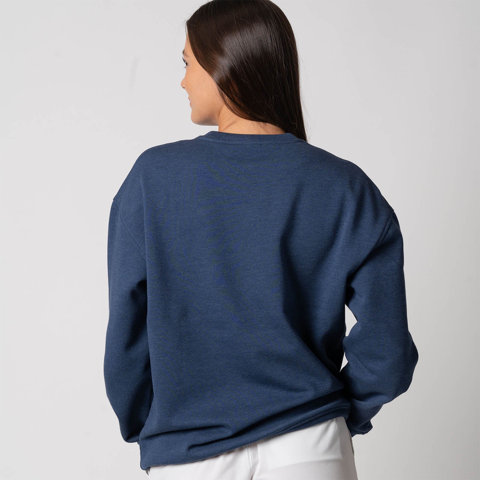 Image showing the back of a female model who is wearing a JOOLA Unisex Fleece Crew, Navy.