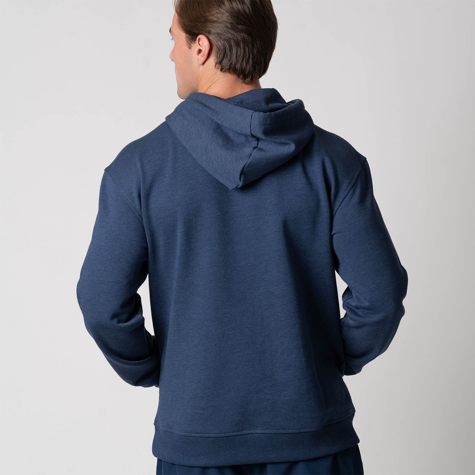 Image showing the back of a male model who is wearing the JOOLA Unisex Fleece Hoodie, Navy.