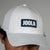 White cap with JOOLA logo on a gray background.