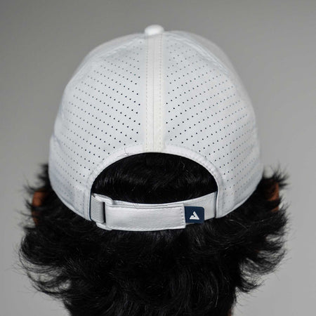 White baseball cap with a JOOLA brand logo on the back, worn by a person with dark hair.
