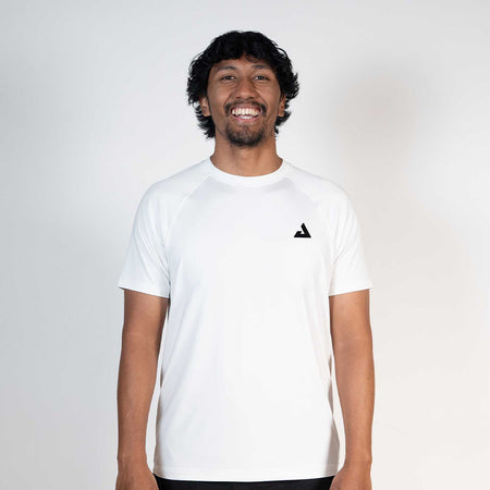 Person wearing a white t-shirt with a black JOOLA Trinity logo on a plain background