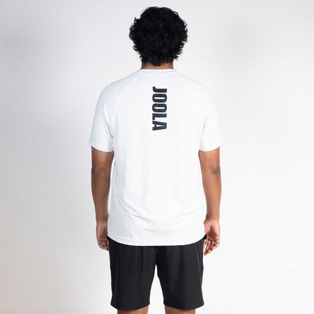 Person wearing a white t-shirt with JOOLA branding on the back against a plain background