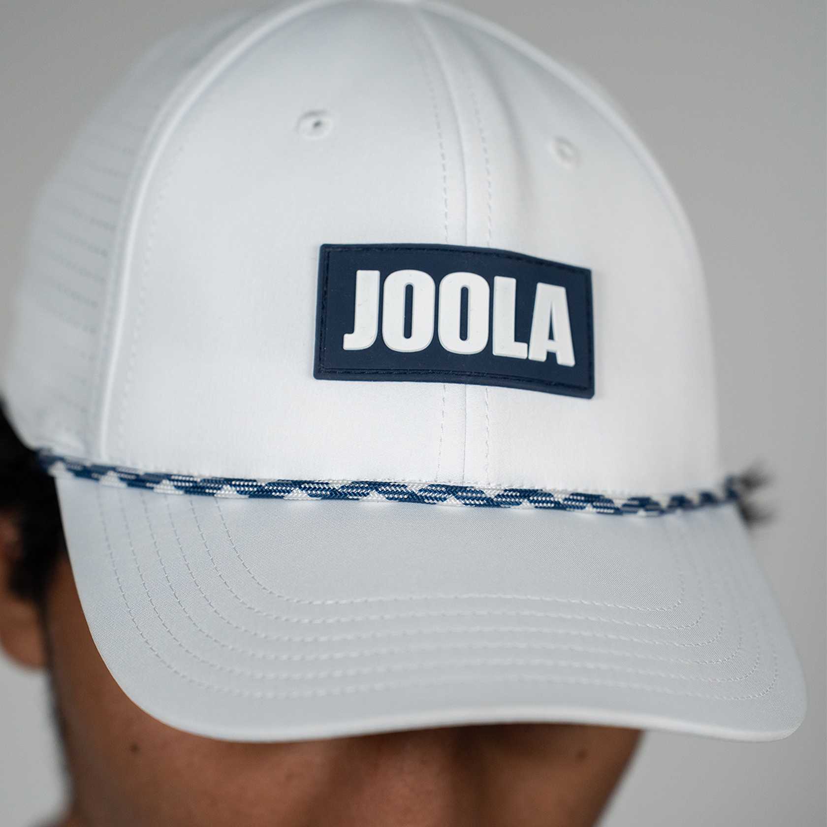 White JOOLA Perforated Rope Cap.