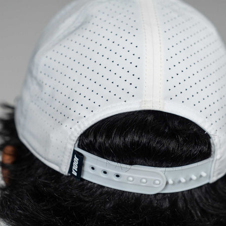 Close-up of the back of a JOOLA Perforated Rope Cap in White with a Black and White tag.