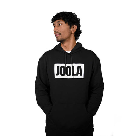 Person wearing a black hoodie with 'JOOLA' logo on a white background
