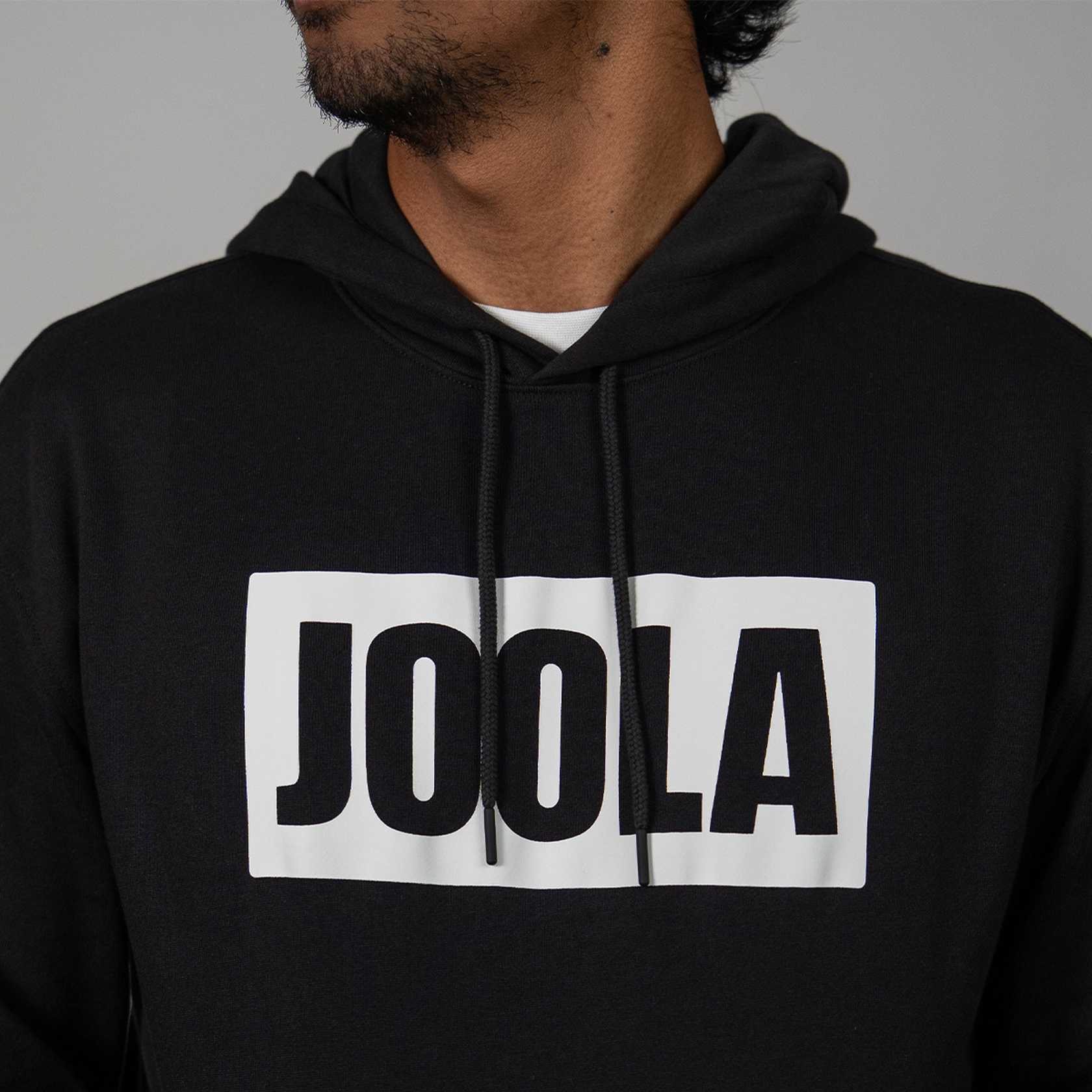 Black hoodie with 'JOOLA' logo on a gray background.